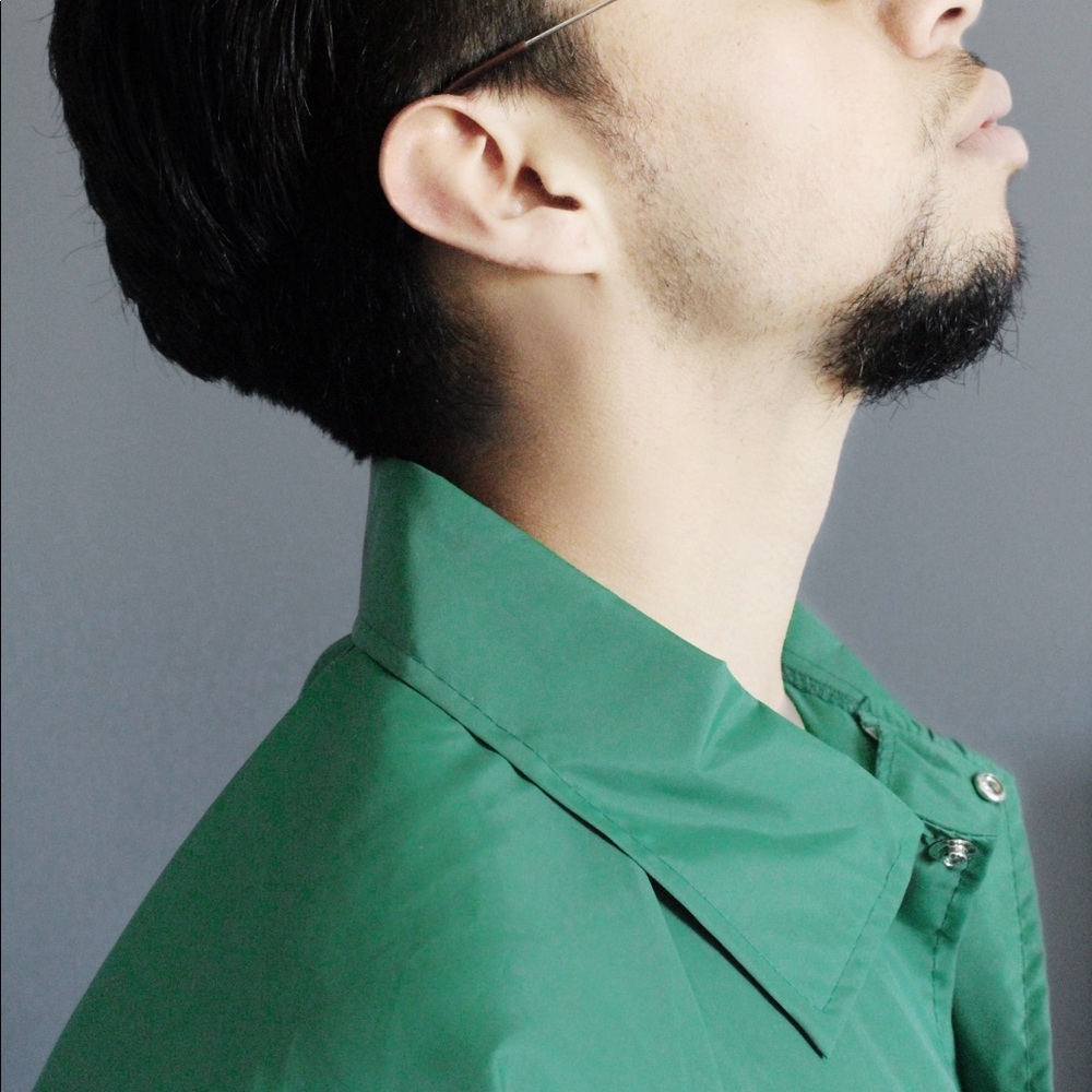 A European-styled green button-up jacket.